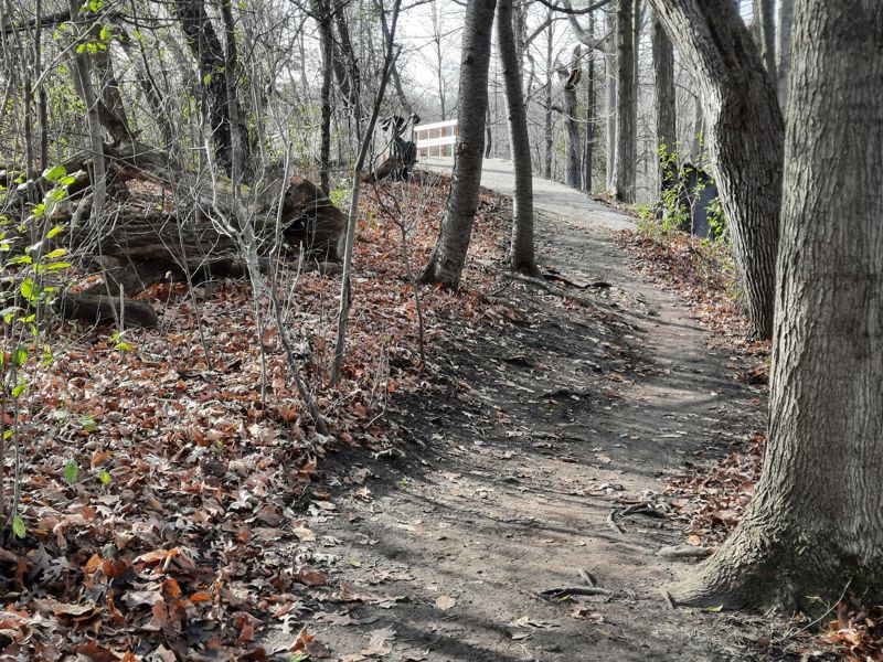 Trail up to a new bridge over stormwater spillway